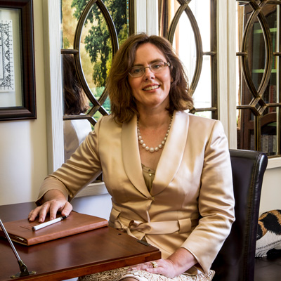 photo portrait of C. Elizabeth Leach at her desk